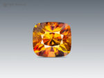 2.90-carat cushion-cut sphene from Zagi Mountain, Pakistan, showing green, yellow, and golden flashes with intense fire.