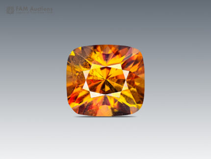 2.90-carat cushion-cut sphene from Zagi Mountain, Pakistan, showing green, yellow, and golden flashes with intense fire.