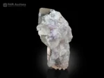 Quartz crystals with sharp, lustrous terminations alongside pale pink morganite, forming an elegant miniature specimen.