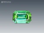 Emerald cut tourmaline gemstone showing blue and green tones with clean facet structure