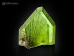Natural peridot crystal with olive green color and ludwigite inclusions