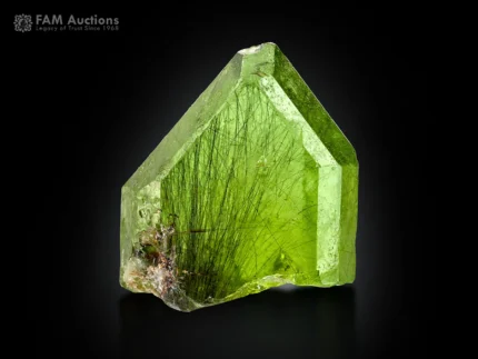 Natural peridot crystal with olive green color and ludwigite inclusions