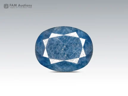 12.95 ct oval cut blue sapphire gemstone from Madagascar showing pink fluorescence under UV light