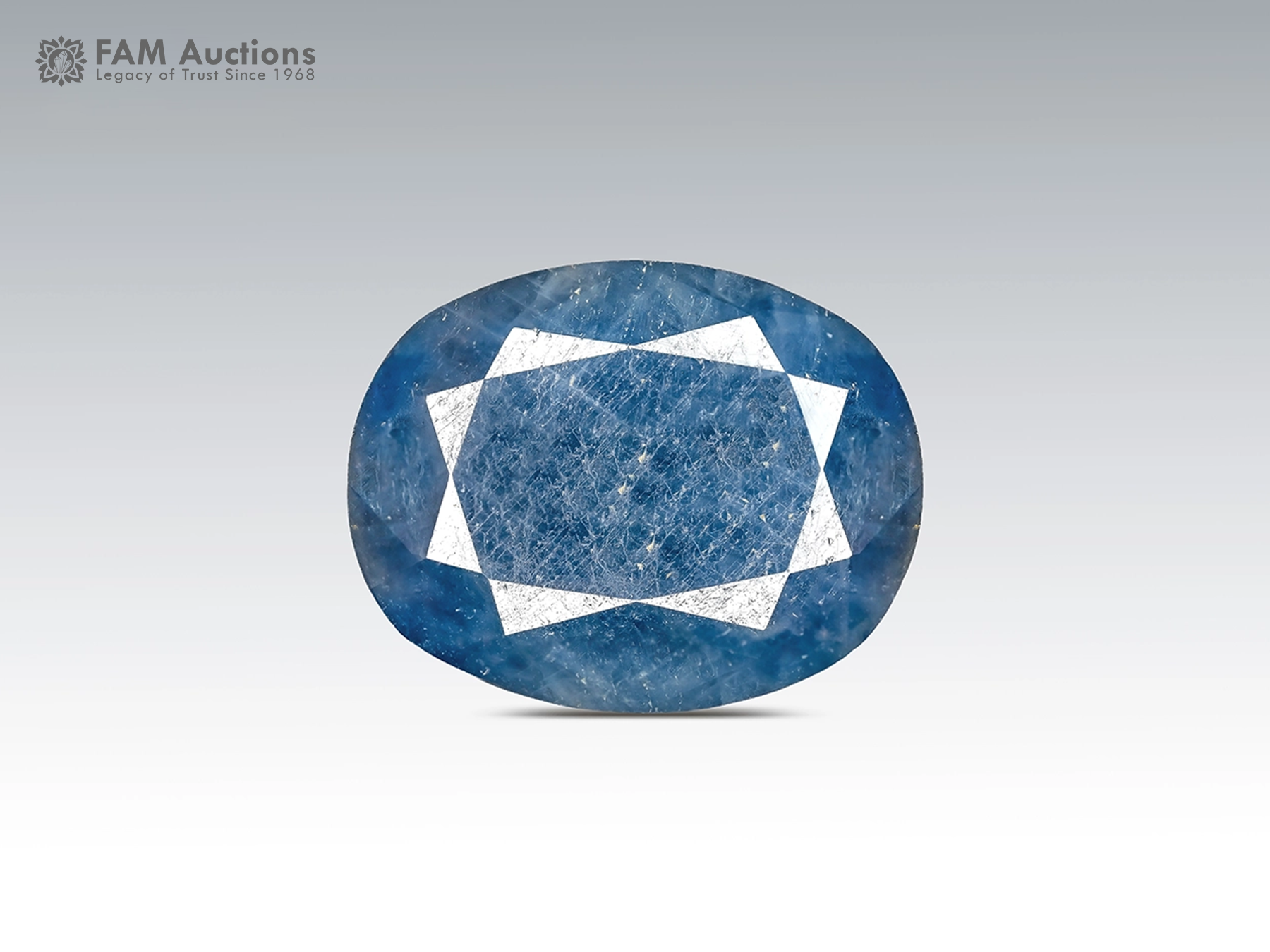 12.95 Carat Oval Cut Blue Sapphire from Madagascar 12.95 ct oval cut blue sapphire gemstone from Madagascar showing pink fluorescence under UV light