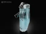 Gemmy blue aquamarine crystal with contrasting black schorl crystals.