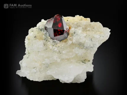 Spessartine garnet crystal with fiery red color on white albite matrix