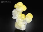 Sculptural lemon yellow brucite crystal formation with white crystalline base.