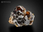 Brown andradite garnet crystals with glossy luster and sharp faces on natural matrix.