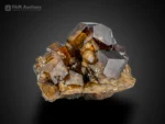Brown andradite garnet crystals with glossy luster and sharp faces on natural matrix.
