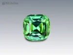 Blue-green cushion-cut tourmaline gemstone with eye-clean clarity.