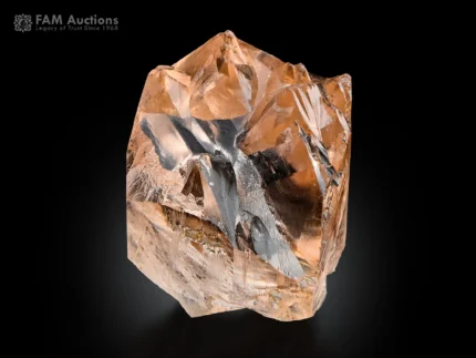 Champagne-colored, etched topaz crystal with a sharp form from Pakistan.