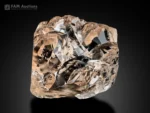 Etched topaz crystal from Pakistan with sharp termination and natural surface texture on dark background.