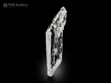 Transparent faden quartz crystal with elongated shape and visible internal faden line on dark background.