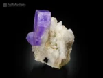 Purple apatite crystal on albite matrix, vibrant color specimen.