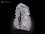 Apatite crystal with purplish tone and green actinolite inclusions on display.