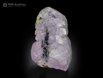 Apatite crystal with purplish tone and green actinolite inclusions on display.