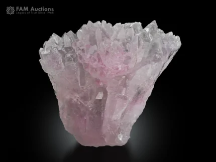 Rose quartz cluster with a light pink color and well-formed crystal shape.