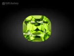 Natural 1.30 carat cushion-cut peridot gemstone from Pakistan with vivid apple green color and excellent luster.