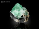 Green fluorite crystal with black schorl creating a strong contrast.