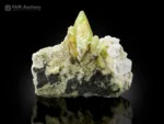 Green titanite crystals with chlorite spray on matrix showing strong luster.