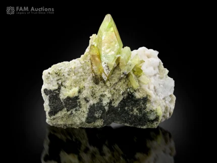 Green titanite crystals with chlorite spray on matrix showing strong luster.