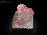 Pink rose quartz crystal formation on transparent quartz matrix.