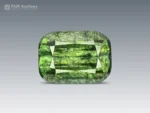 Natural green cushion-cut gemstone weighing 7 ct with distinctive Ludwigite inclusions