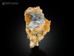 Pale blue celestine crystal cluster on contrasting calcite matrix.