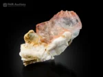 Gemmy pink fluorite crystals with muscovite and albite matrix.