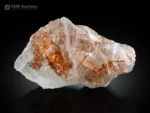 Transparent crystal with golden-orange Rutile in sagenite form included within the crystal and on the surface