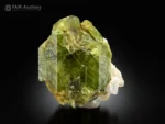 Olive-green diopside crystal associated with white feldspar