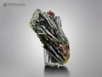 Lustrous black epidote crystals with reddish-brown rutile from Pakistan in a striking mineral association.