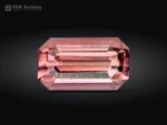 A beautiful 1.65-carat emerald-cut pink tourmaline from Afghanistan, displaying a delicate salmon-pink color and refined brilliance.
