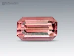 A beautiful 1.65-carat emerald-cut pink tourmaline from Afghanistan, displaying a delicate salmon-pink color and refined brilliance.