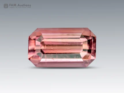 A beautiful 1.65-carat emerald-cut pink tourmaline from Afghanistan, displaying a delicate salmon-pink color and refined brilliance.