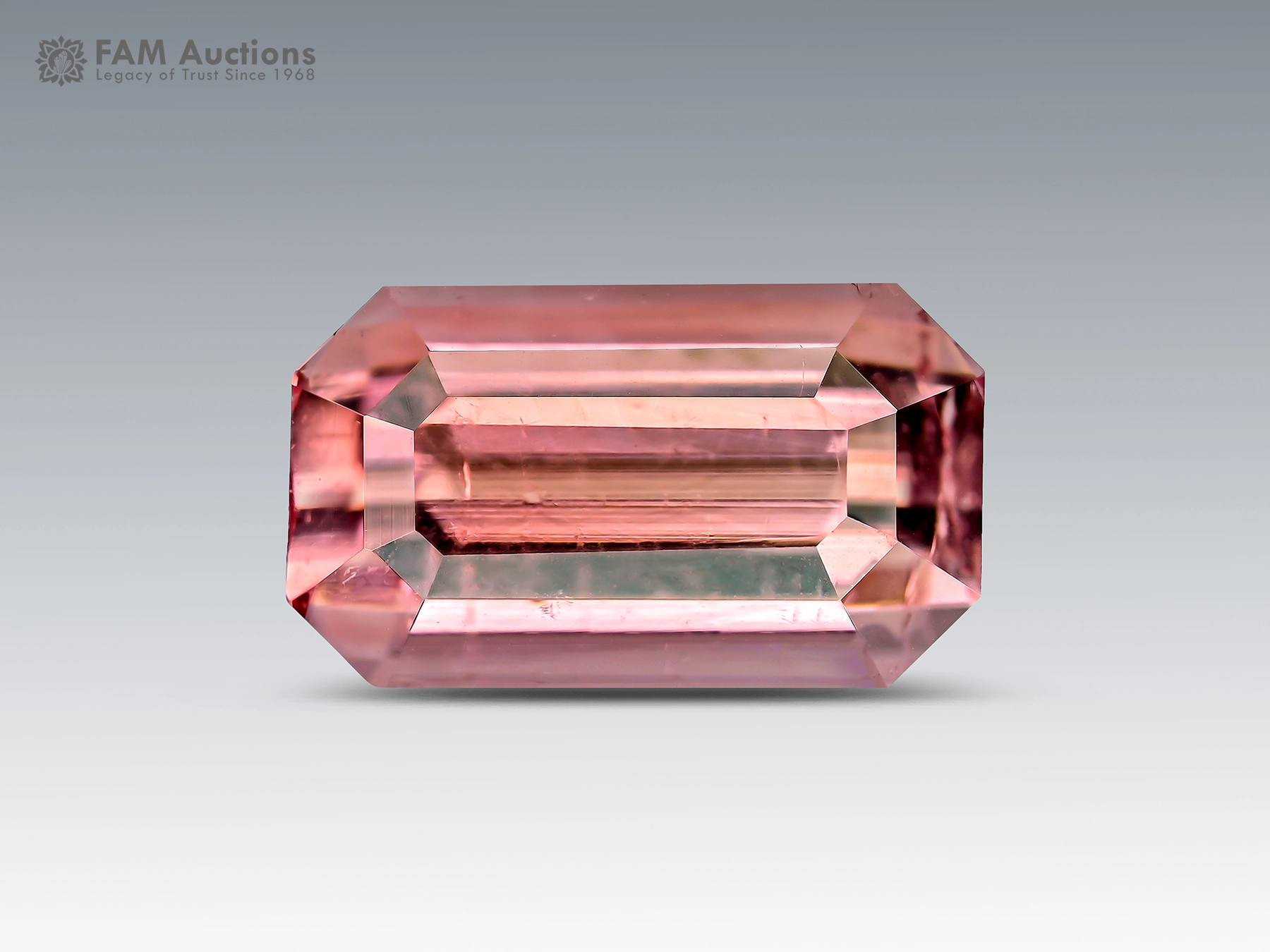 1.65 Carat Emerald Cut Pink Tourmaline – Afghanistan A beautiful 1.65-carat emerald-cut pink tourmaline from Afghanistan, displaying a delicate salmon-pink color and refined brilliance.