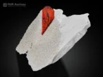 Fiery-red phantom brookite crystal sharply terminated on white matrix.