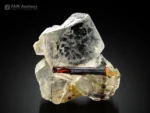 Rutile crystal on clear quartz with fine rutile inclusions.