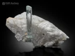 Slender blue aquamarine crystal on contrasting white feldspar matrix