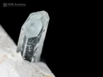 Slender blue aquamarine crystal on contrasting white feldspar matrix