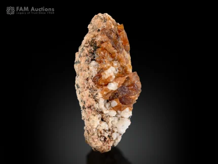 Orange-brown bastnasite crystals on a contrasting matrix.
