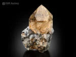 Rutile-included quartz crystal on matrix with golden rutile needles.