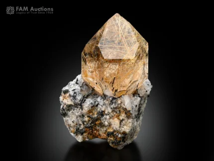 Rutile-included quartz crystal on matrix with golden rutile needles.