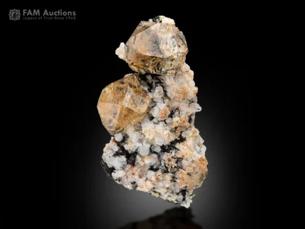 Rutile included quartz crystals with golden needle inclusions on contrasting mineral matrix