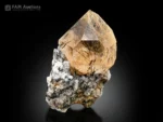 Rutile-included quartz crystal on matrix with golden rutile needles.