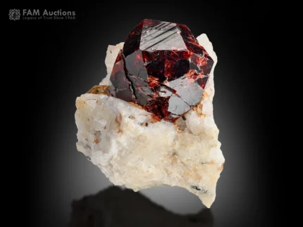 deep red spessartine garnet crystal on albite matrix with muscovite and strong color contrast.