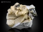 Tourmaline crystals with strong striations on a contrasting feldspar matrix