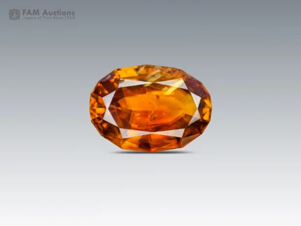 Natural oval cut Sphene featuring rich golden orange color, warm amber tones, and lively brilliance.