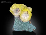 Rounded yellow brucite crystal cluster on green chrysocolla matrix from Killa Saifullah, Pakistan.