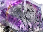 Purple fluorite crystals with dark riebeckite inclusions and contrasting albite.